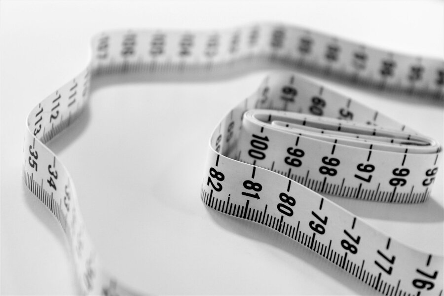 A coiled white soft tape measure used for sewing