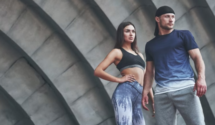 A sports couple resting after a workout is a sexy woman and a man.