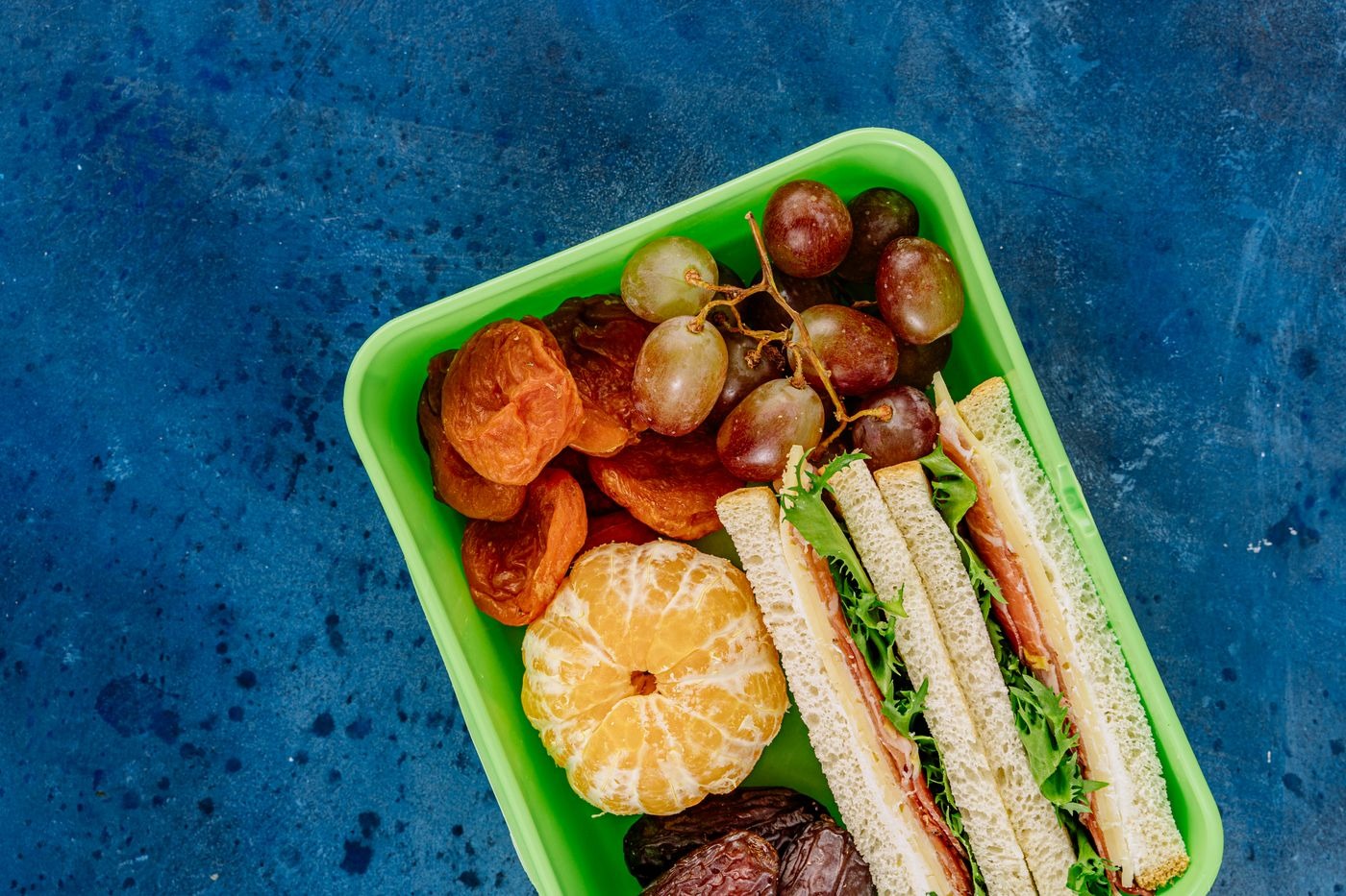 Stock photo of a sandwich and fruit packed in a lunch box, not a listed product
