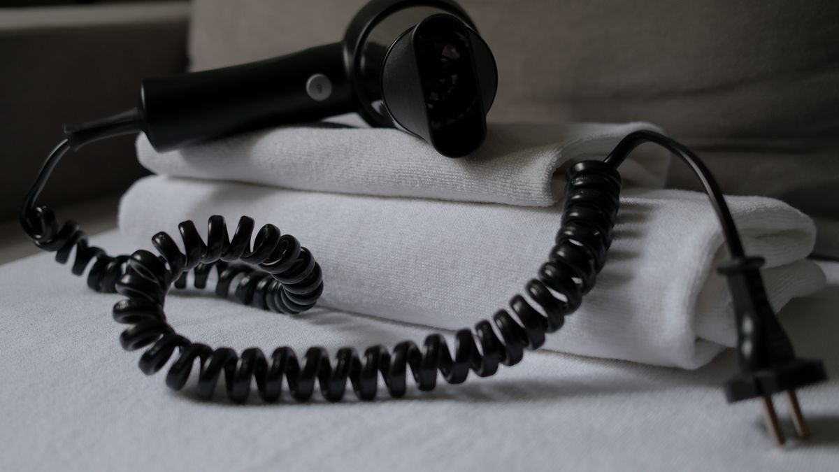 Stock photo: a hair dryer resting on folded towels
