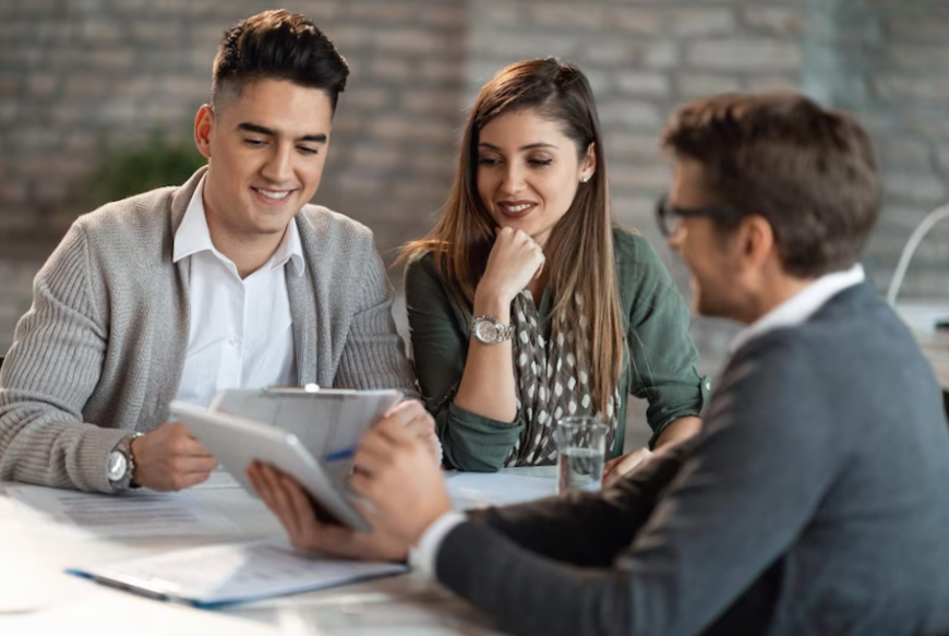 young happy couple having consultations with bank manager on a meeting in the office