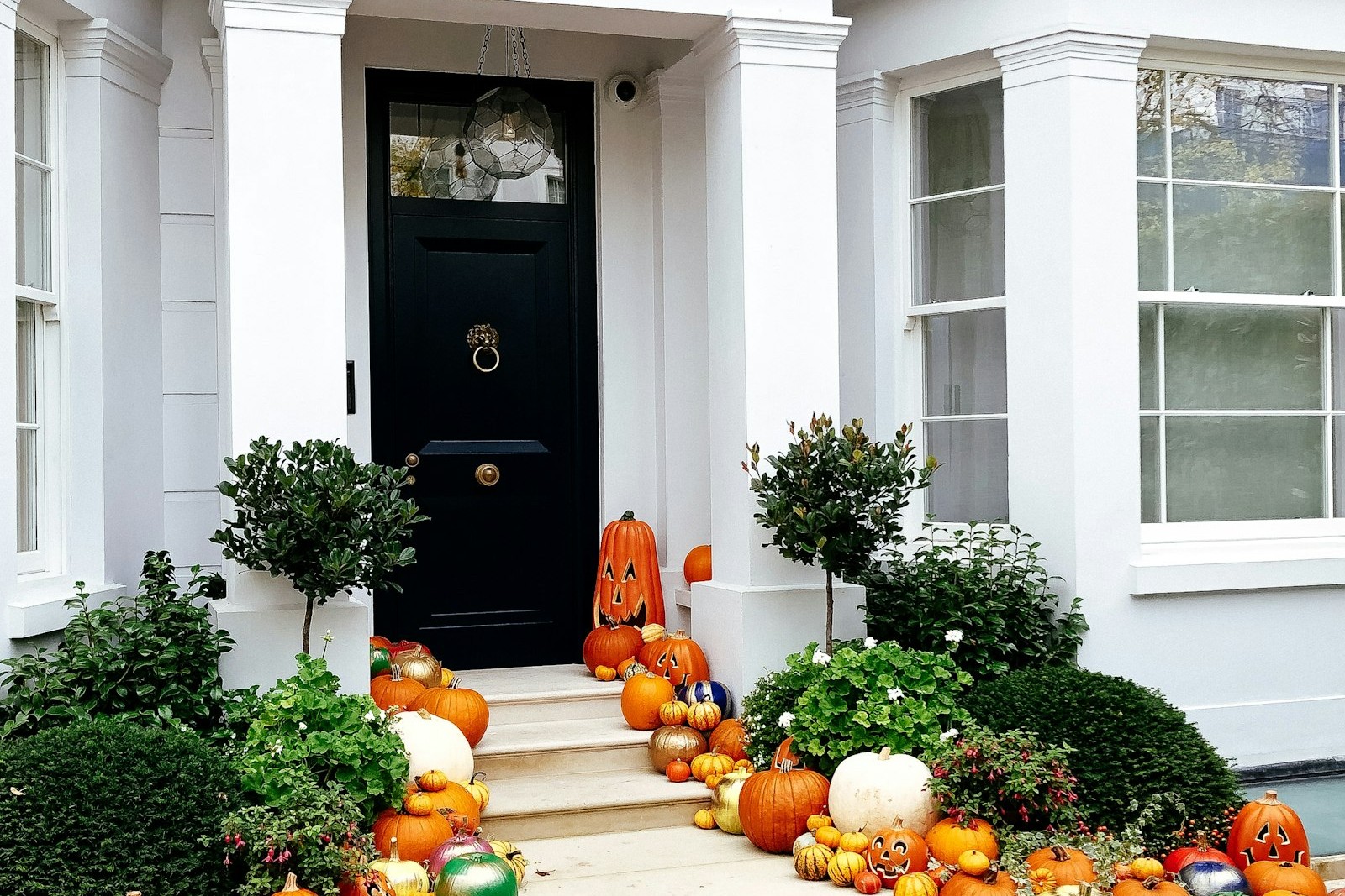 House porch decorated with pumpkins and halloween decorations at dusk