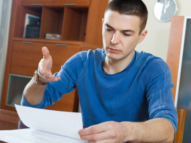 guy fills in financial documents
