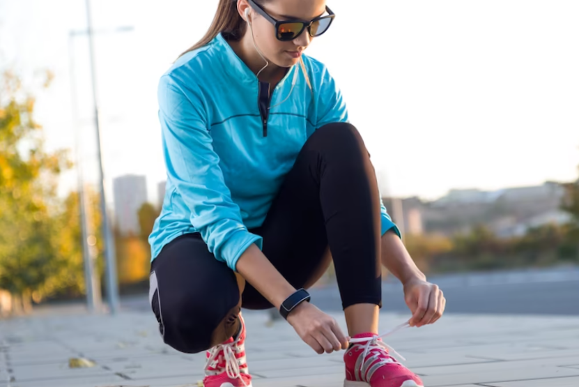 female athlete tying laces for jogging.