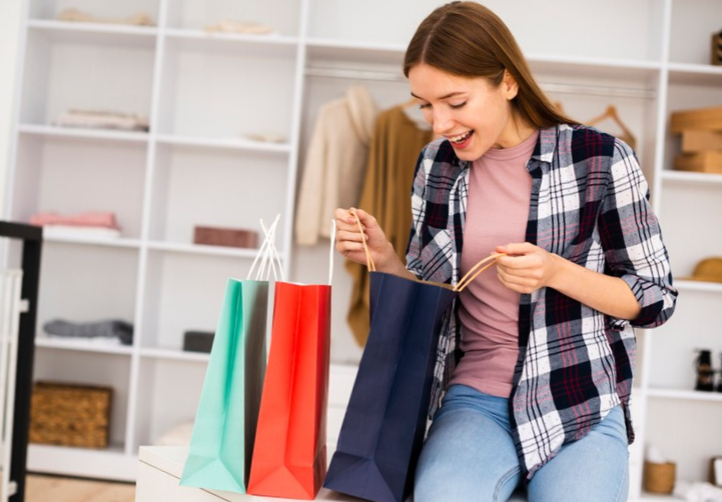 Long view of woman looking into the paper bags