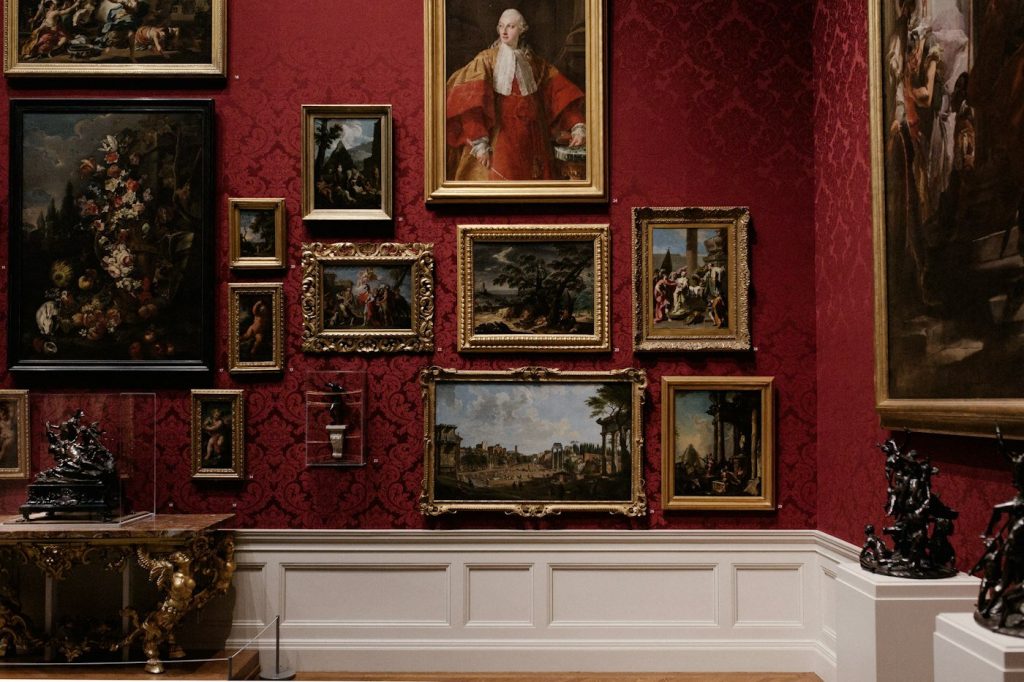 A wall with an arrangement of framed pictures in different sizes