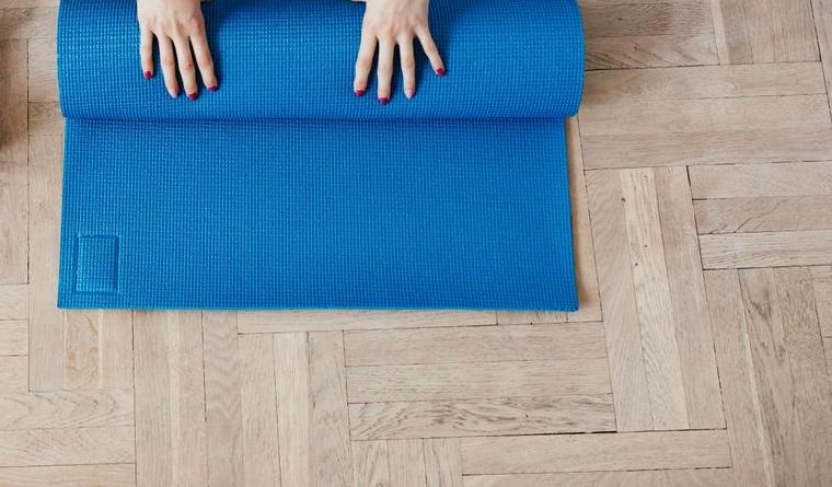 Stock photograph of a generic yoga mat in use, not a listed product