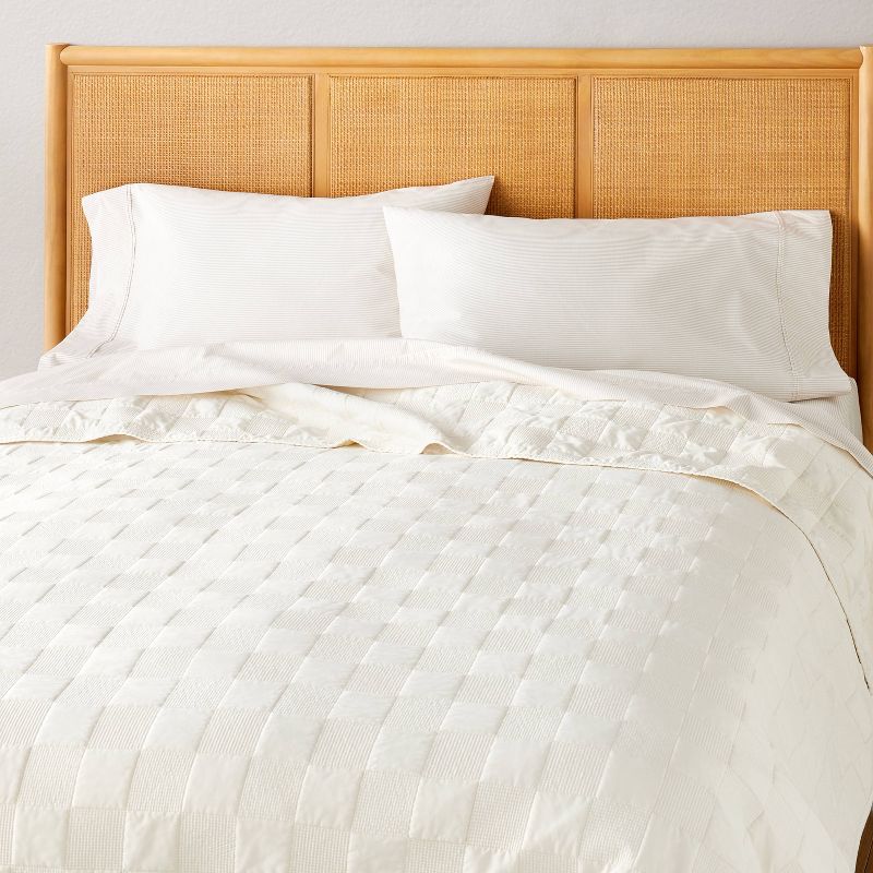 Hearth and Hand with Magnolia cream checkerboard stitch quilt on a bed