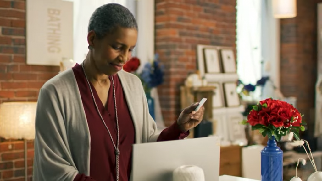 woman entering credit card information into computer