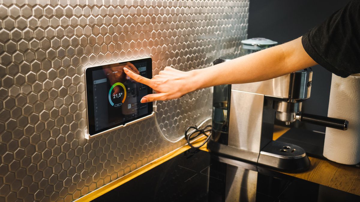 Stock photo: adjusting the temperature on a wall-mounted smart home panel