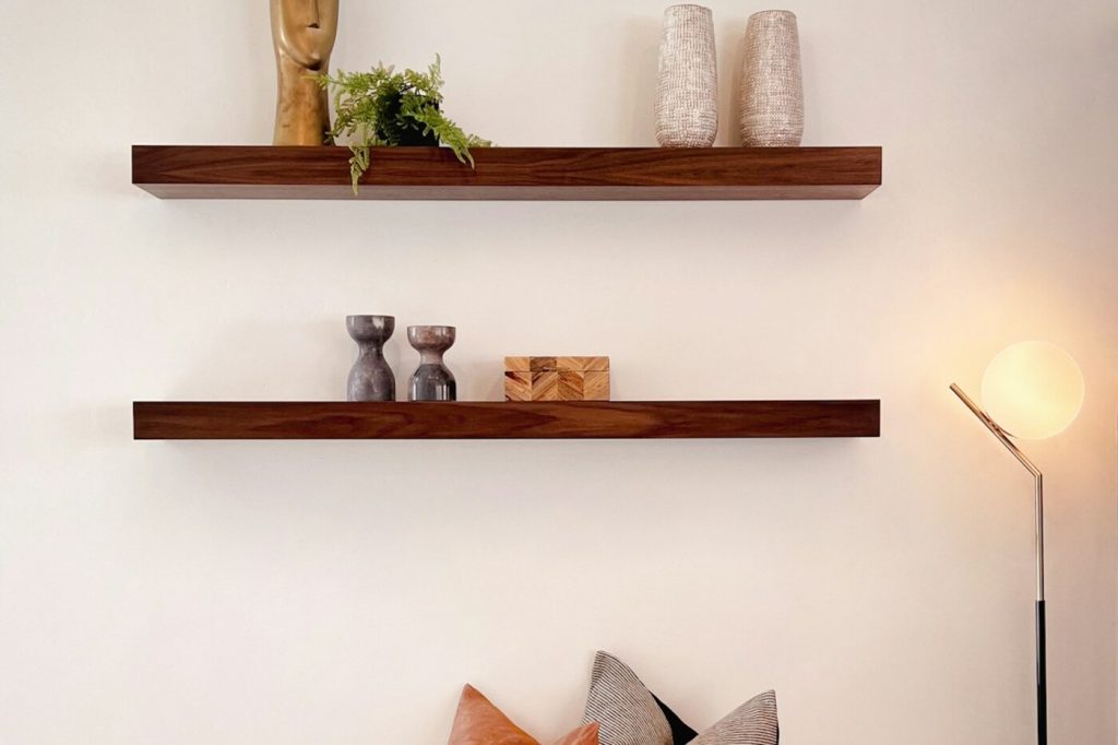 Two wall-mounted shelves above a sofa; free Unsplash photo