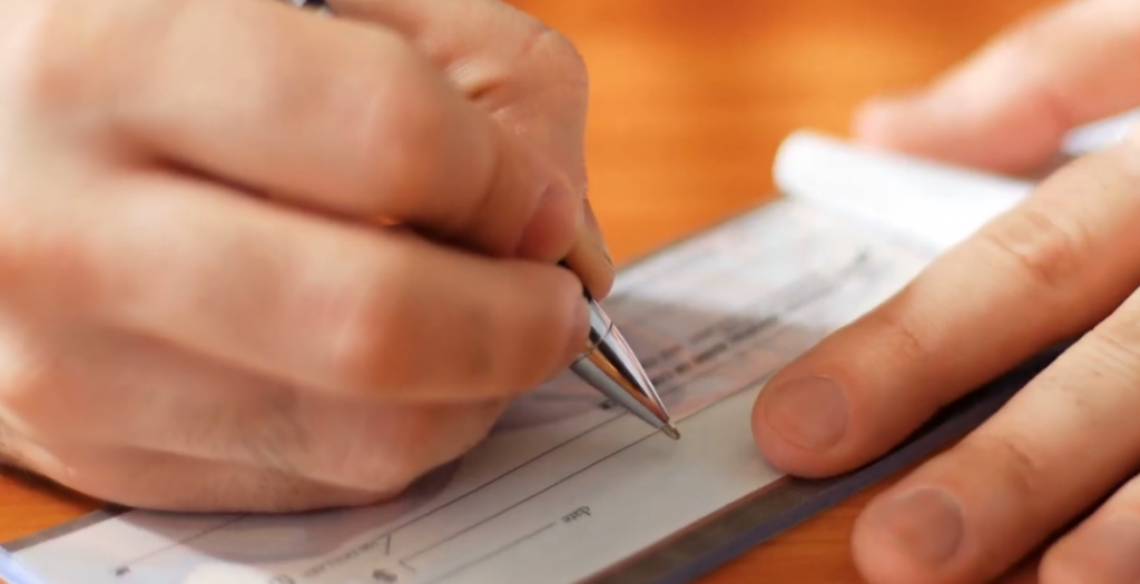 hand signing a check