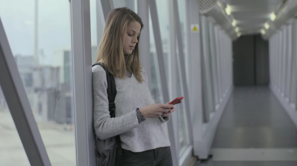 woman checking her phone at airport