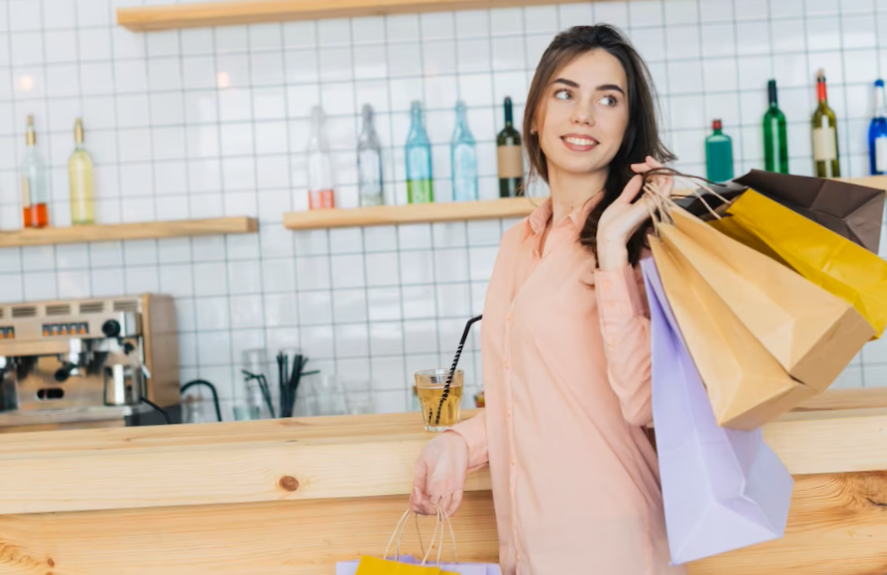 Woman with paper bags near counter