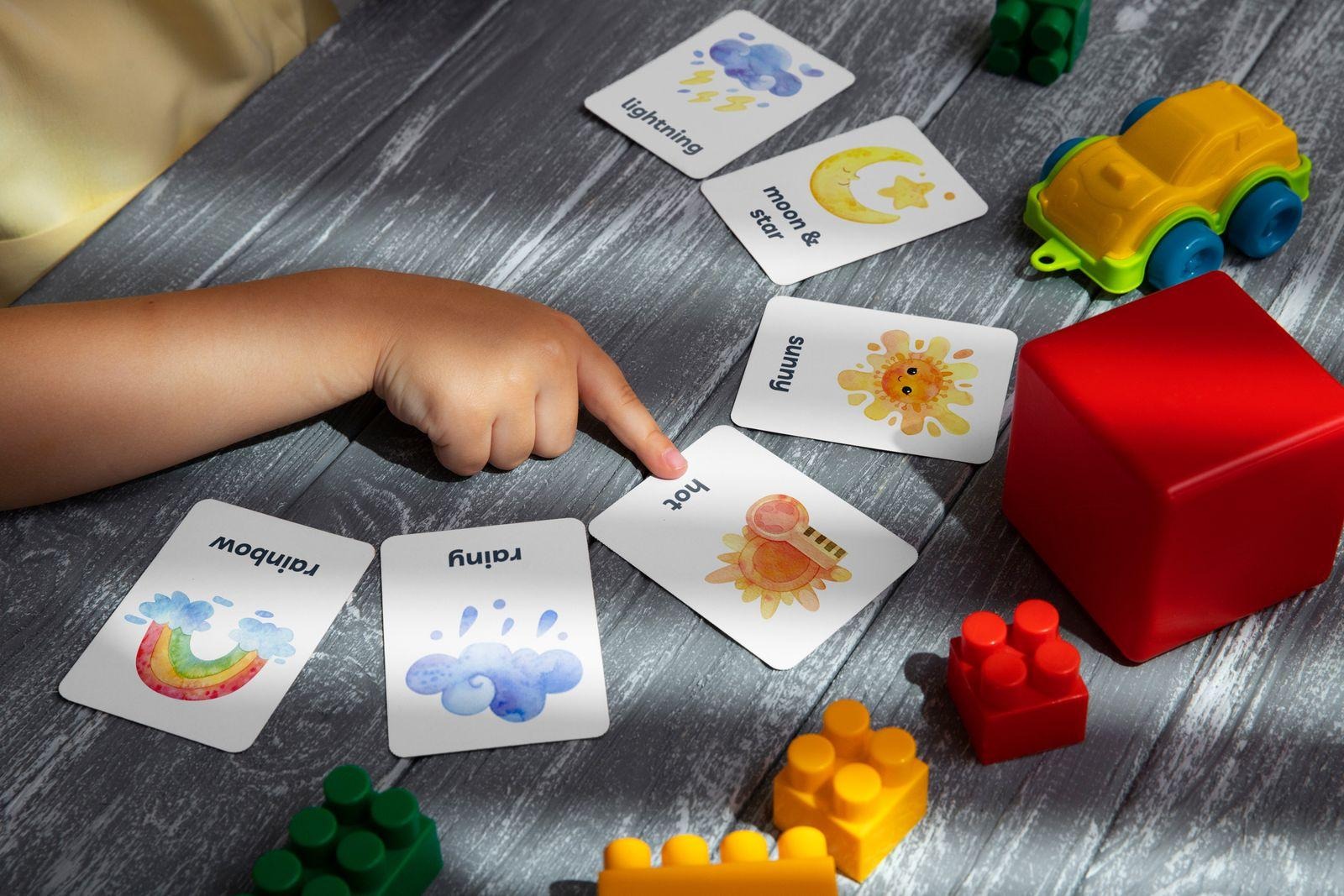 Stock scene of a child using learning cards and toys, not the listed games