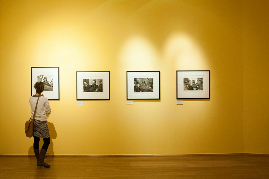 Three black wooden frames hung in a row on a light wall