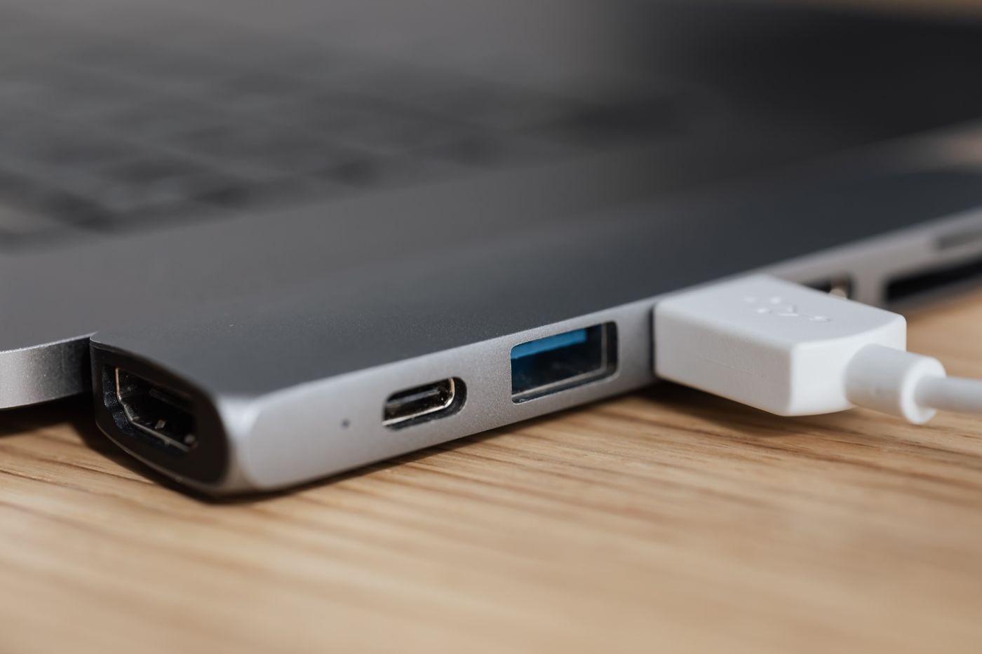 Stock photo of a laptop with a charging cable and ports, not a listed product