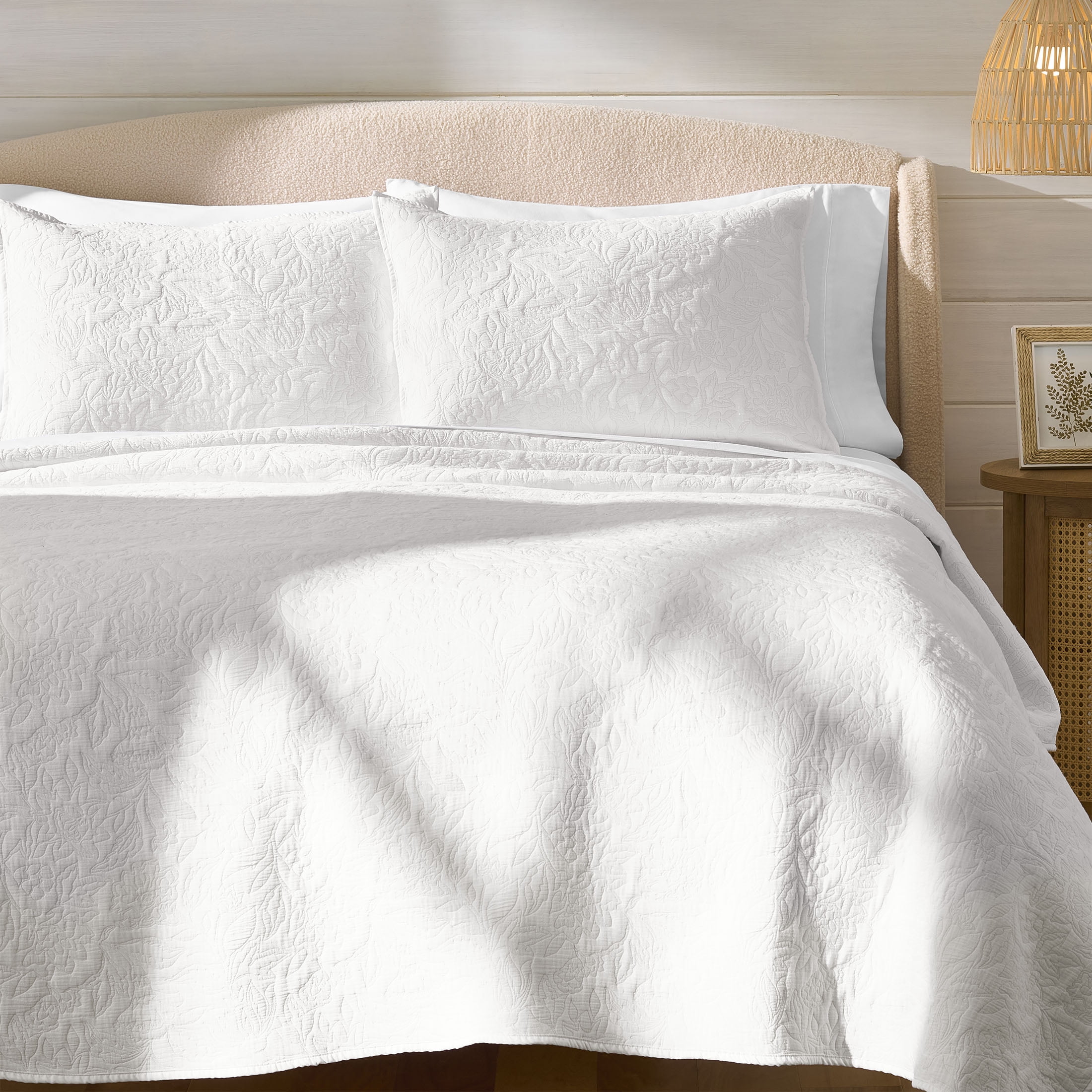 Better Homes and Gardens white floral matelasse quilt on a bed